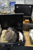 Two black japanned tin trunks containing ladies' hats, wooden boxes etc.