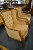 A pair of French style beech framed wing back armchairs.