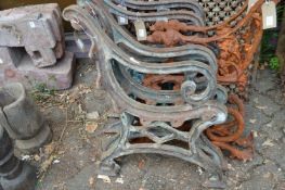 A pair of heavy cast iron bench ends.