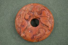 A small Chinese carved hardstone disc.