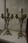 A pair of decorative four light, three branch candelabra.