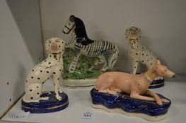 A Staffordshire zebra, a pair of dogs and a greyhound inkwell.