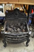A Regency style cast iron fire grate.