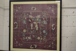 A large Chinese embroidered panel, framed and glazed.