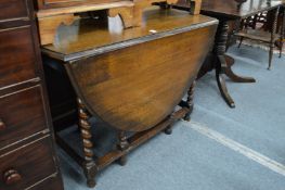An oak drop leaf gate leg dining table.