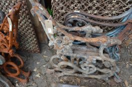 A pair of heavy cast iron bench ends.