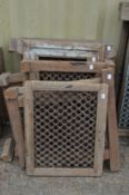 A quantity of Indian hardwood framed wrought iron window grilles.