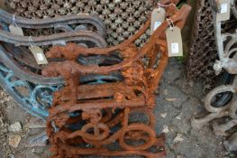 A pair of heavy cast iron bench ends.