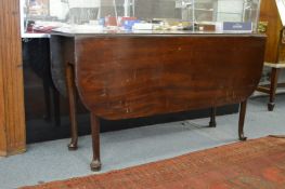 A mahogany drop leaf, gate leg, pad foot dining table.
