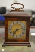 A miniature walnut bracket clock.