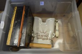 An old toilet roll holder, porcelain flush pull and a tin box.