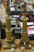 A pair of large ornate brass lamp bases.