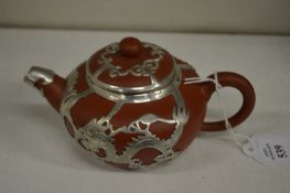 A Chinese metal mounted Yixing teapot.