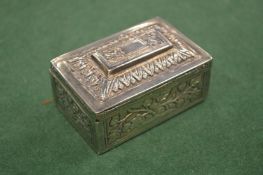 An embossed white metal box with hinged cover.