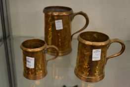 A graduated set of three brass measures.