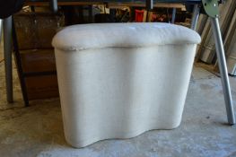 An upholstered box ottoman.
