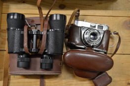 A cased pair of binoculars and a camera.