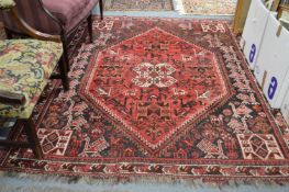A Persian carpet, red ground decorated with various animals and birds 230cms x 180cms.