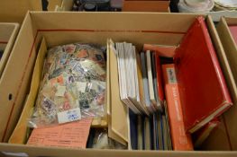 A box containing numerous loose stamps, albums and books.