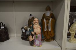 Three Chinese figures depicting a Buddha and two sages.