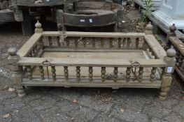An Indian hardwood rectangular cradle or plant trough with turned spindle supports.