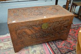 A Chinese carved camphor wood coffer.