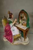 A Dresden porcelain group of a lady seated at her dressing table.