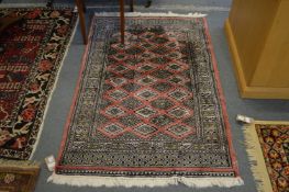 A small Bokhara style rug 150cms x 95cms.