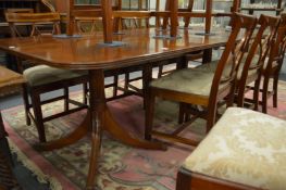 A good Georgian design mahogany twin pillar extending dining table with one extra leaf.