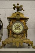 An ornate Victorian brass mantle clock.
