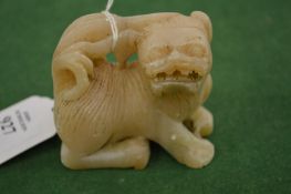 A small Chinese carved hardstone lion.