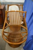 A pair of bamboo revolving conservatory armchairs.