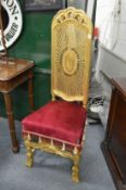 A decorative gilt framed high back chair.