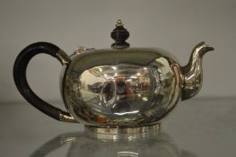 A small silver teapot.