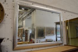 A modern mirror with silver coloured frame.