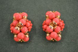 A pair of coral ear clips etc.