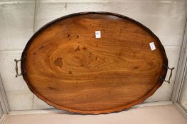 A 19th century mahogany oval tray with brass carrying handles.