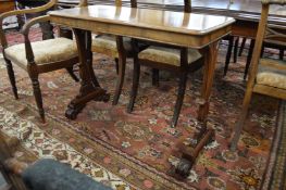 A 19th century mahogany rectangular stretcher table on carved end supports.