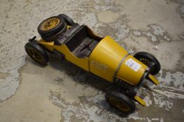 A tin plate model of an old car.