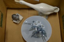 A small Lladro goose and other items.