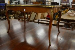 A French style mahogany serpentine shaped coffee table with ormolu mounts.