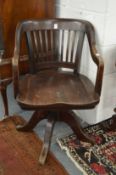 An Edwardian mahogany swivel desk chair.