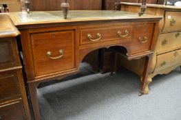 An Edwardian mahogany desk.