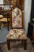 A Gothic revival carved oak and upholstered hall chair.