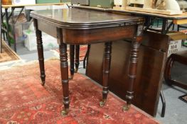 A 19th century mahogany extending dining table with two leaves on turned supports.