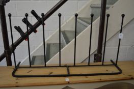 A wrought iron boot rack.