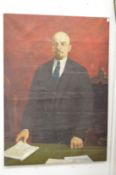 A large oil on canvas portrait depicting Lenin standing by a table, unframed.