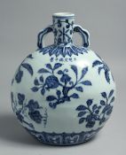 A CHINESE BLUE AND WHITE PORCELAIN TWIN HANDLE MOON FLASK, decorated with sprays of various