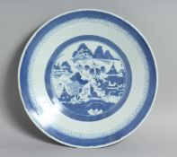 A CHINESE BLUE AND WHITE PORCELAIN DISH, the central roundel containing a landscape scene