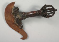A LARGE TIBETAN BRONZE VAJRA, with traces of gilt and red paint, 33cm long.